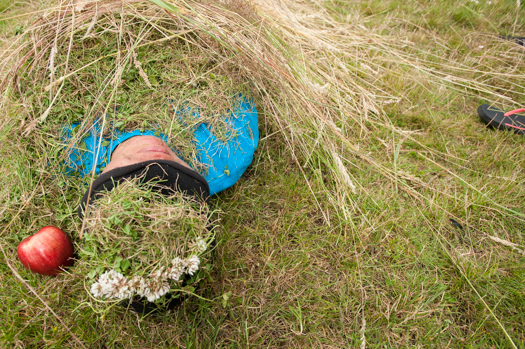 Taking a nap before lunch an aboriginal youth worker is buried in grass. (Penelakut First Nation)